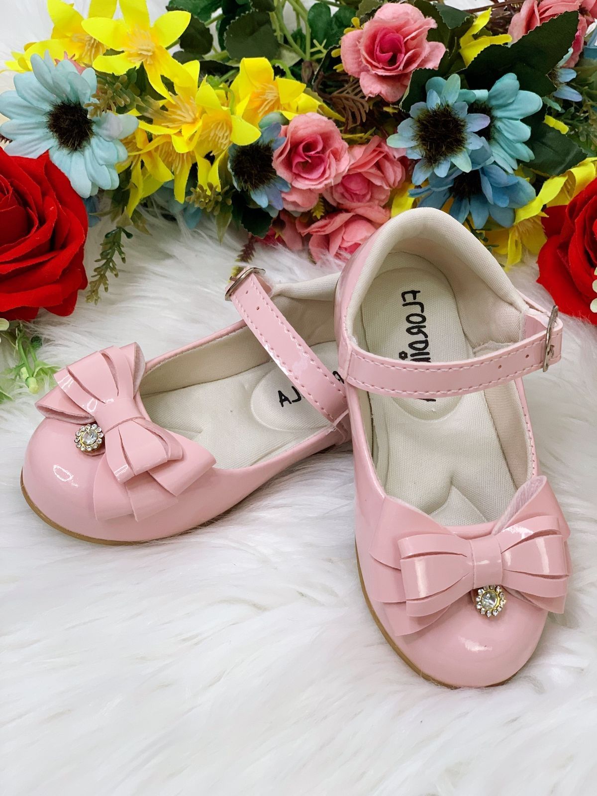 Zapatos de charol rosa con lazo y flor de pedrería