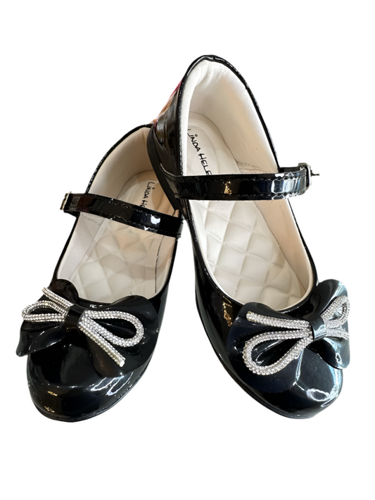Zapatos infantiles de charol negro con lazo y aplique de pedrería
