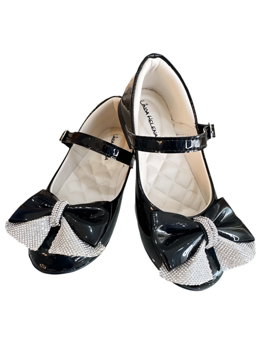 Zapatos infantiles de charol negro con aplique de lazo de diamantes de imitación 