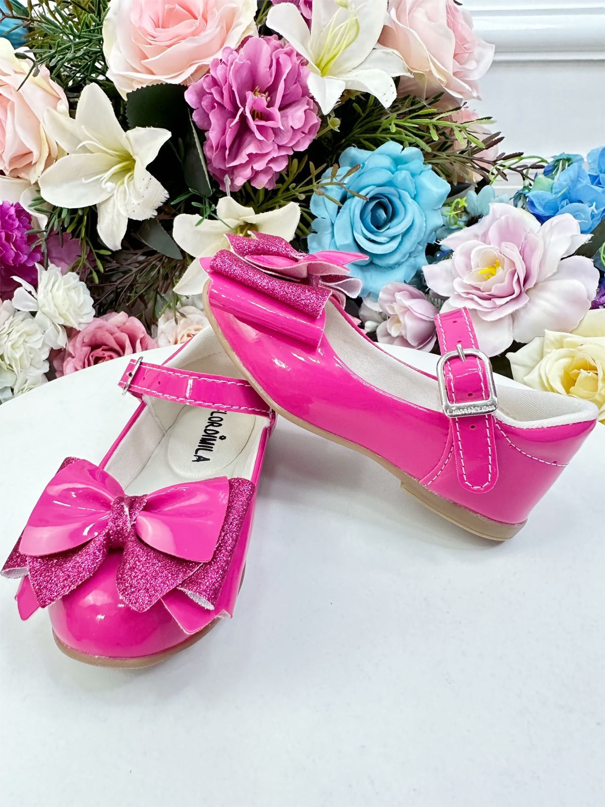 Zapatos de charol rosa de súper lujo con lazo y purpurina