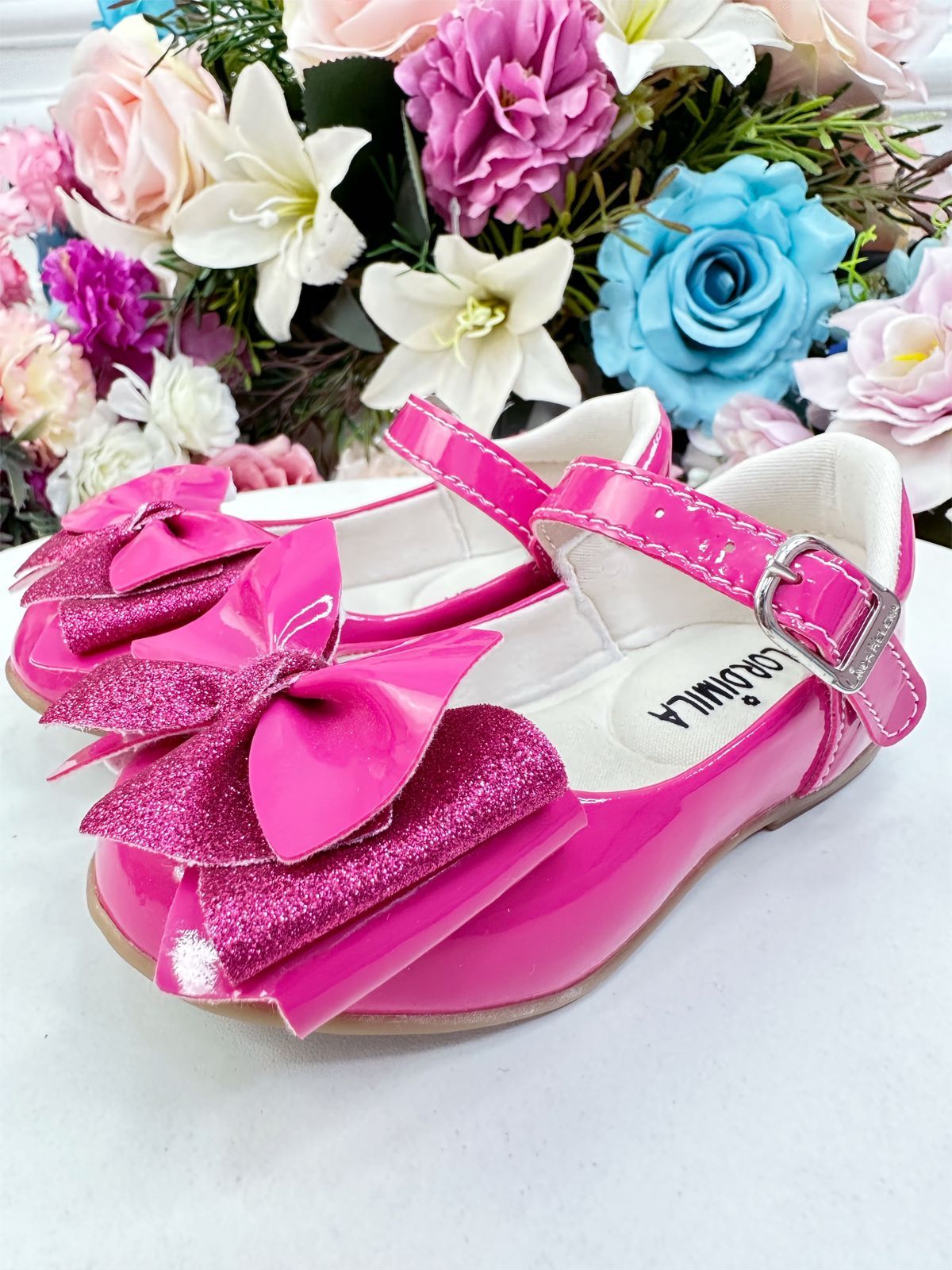 Zapatos de charol rosa de súper lujo con lazo y purpurina