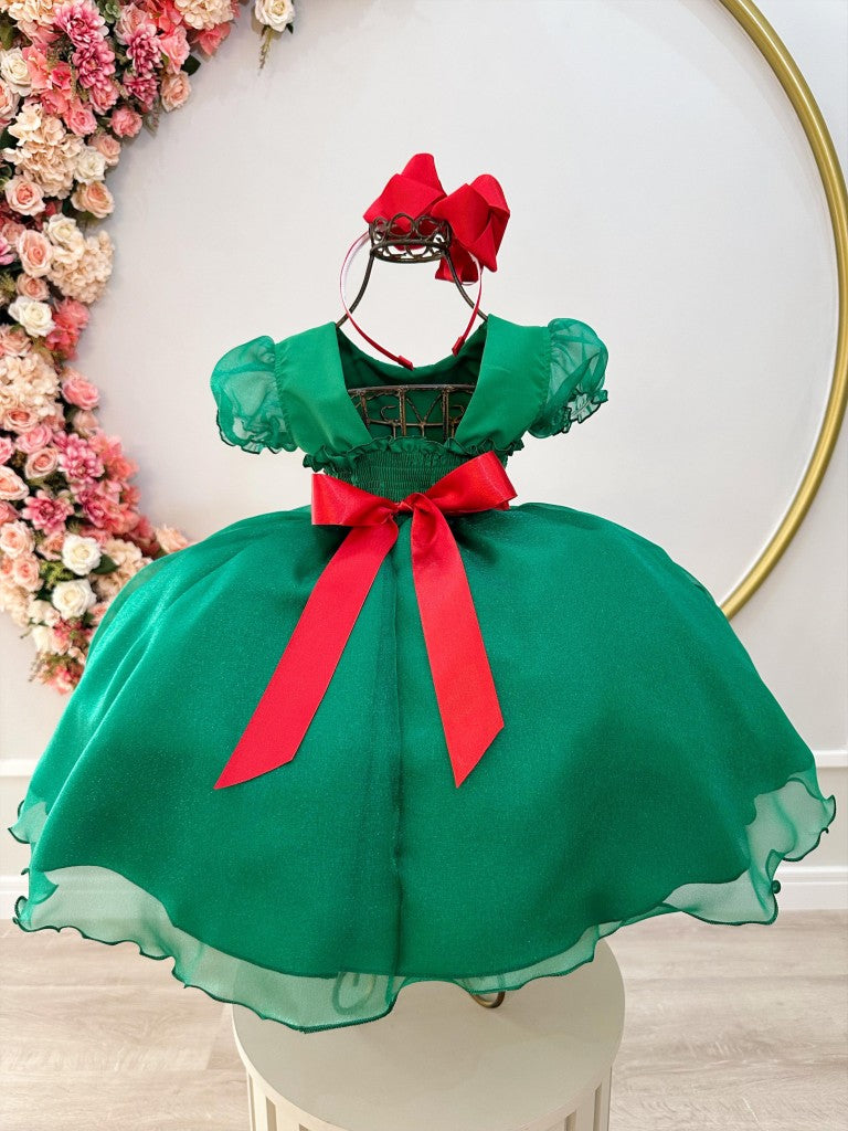 Vestido infantil verde con busto plisado y broche de fiesta navideña