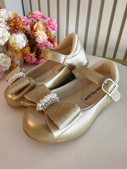 Zapato dorado con aplique de lazo y pedrería brillante 