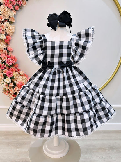 Vestido infantil a cuadros en blanco y negro con broche de lazo