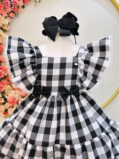Vestido infantil a cuadros en blanco y negro con broche de lazo