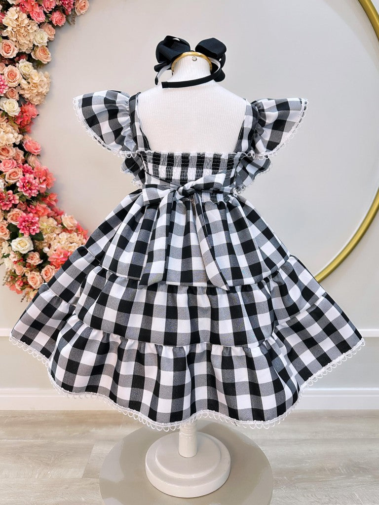Vestido infantil a cuadros en blanco y negro con broche de lazo