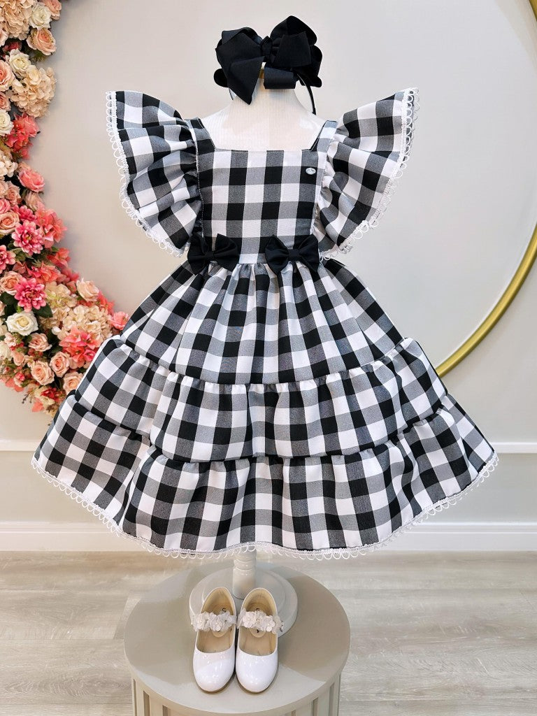 Vestido infantil a cuadros en blanco y negro con broche de lazo