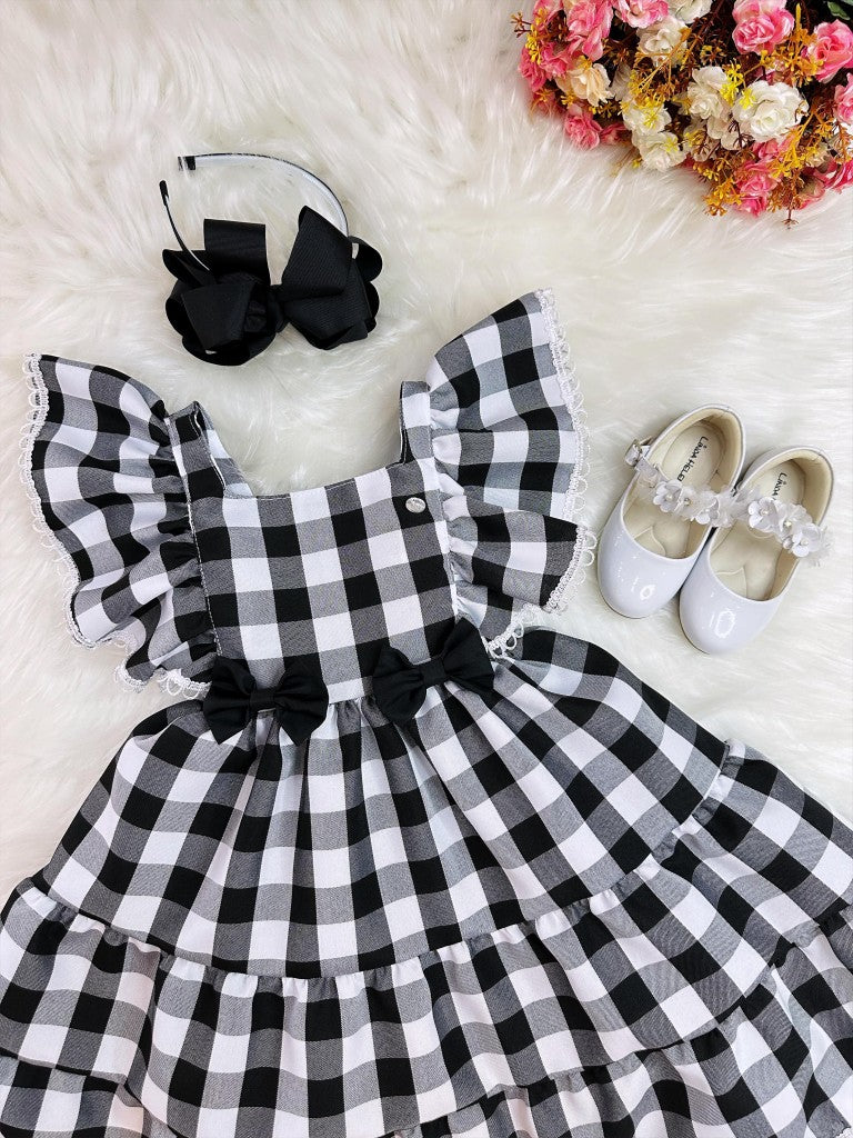 Vestido infantil a cuadros en blanco y negro con broche de lazo
