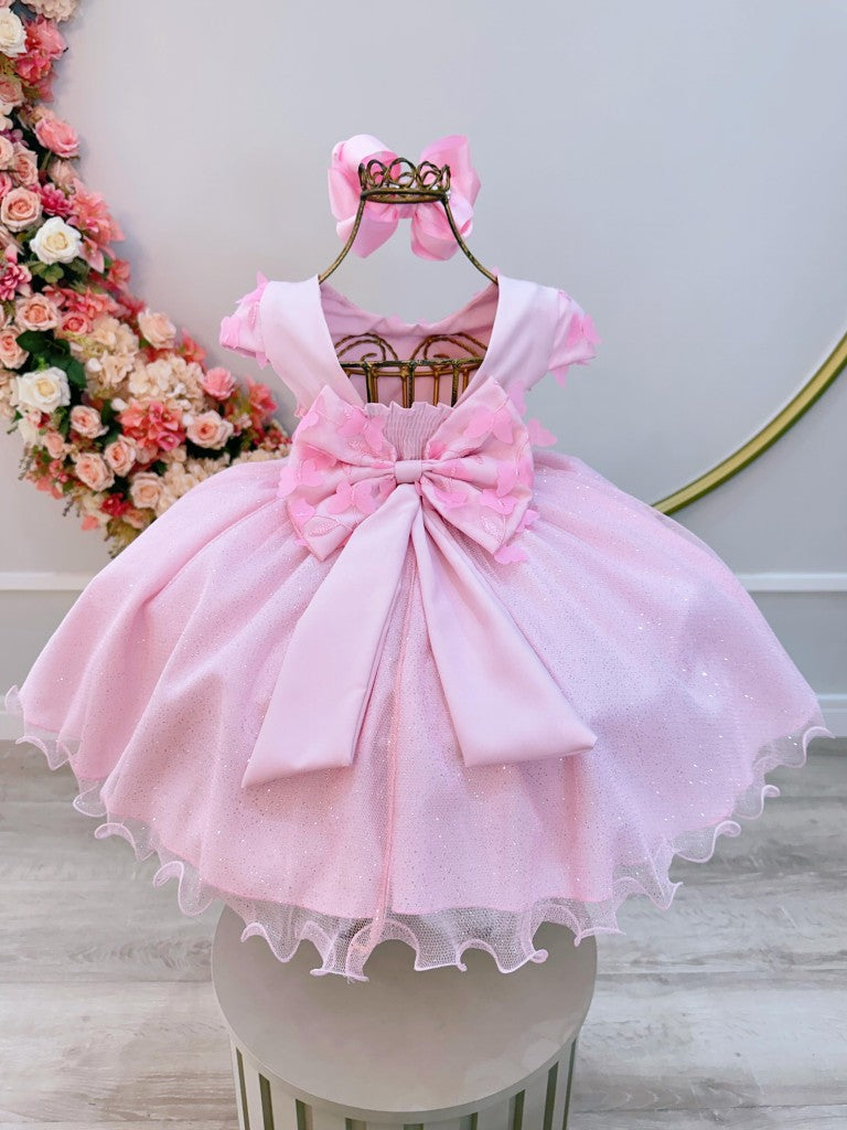 Vestido infantil rosa claro con falda brillante y apliques de flores
