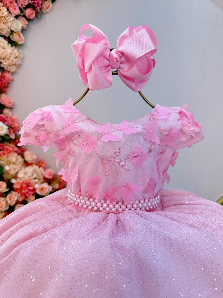 Vestido infantil rosa claro con falda brillante y apliques de flores