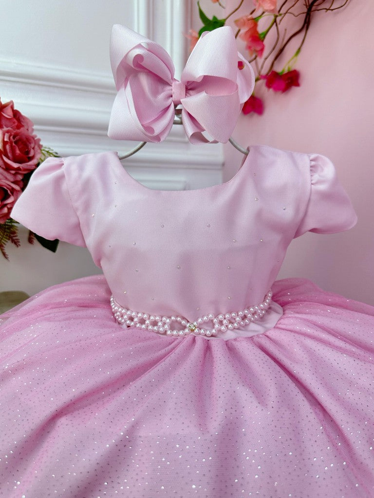 Vestido infantil rosa claro con busto de pedrería y falda con purpurina