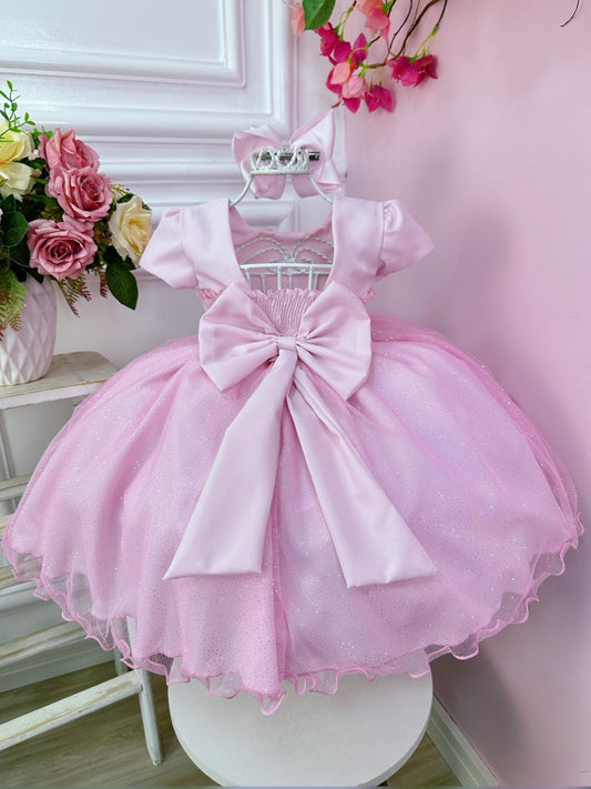 Vestido infantil rosa claro con busto de pedrería y falda con purpurina