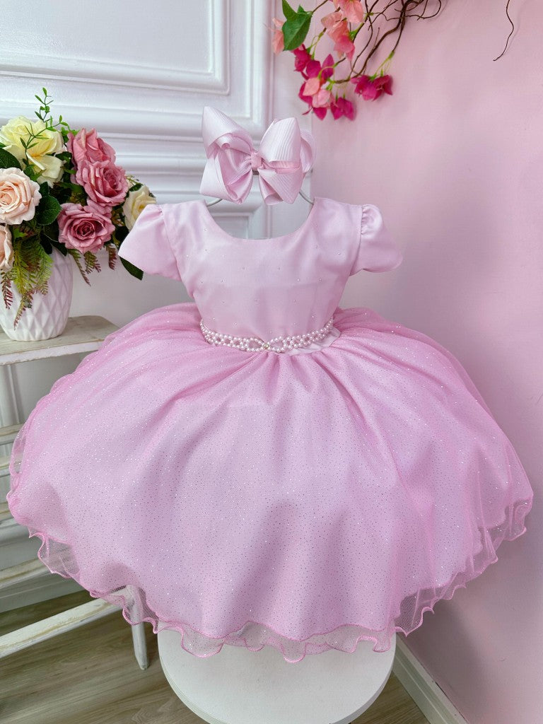 Vestido infantil rosa claro con busto de pedrería y falda con purpurina
