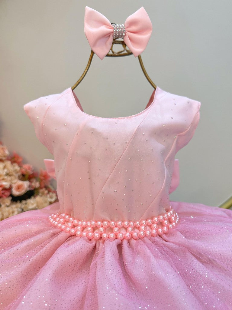 Vestido infantil rosa claro con volantes y falda brillante