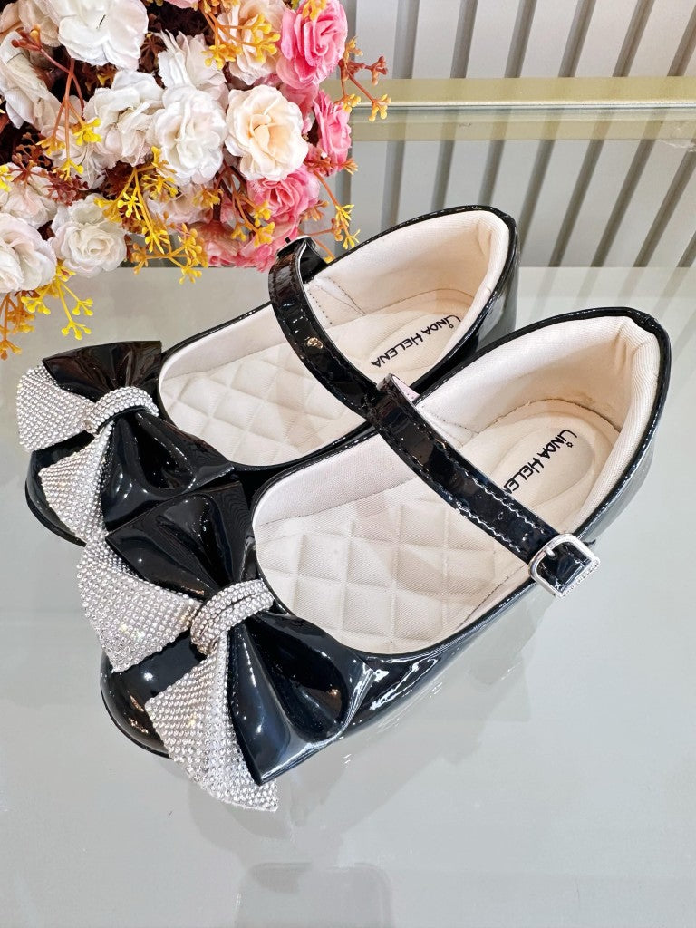 Zapatos infantiles de charol negro con aplique de lazo de diamantes de imitación 