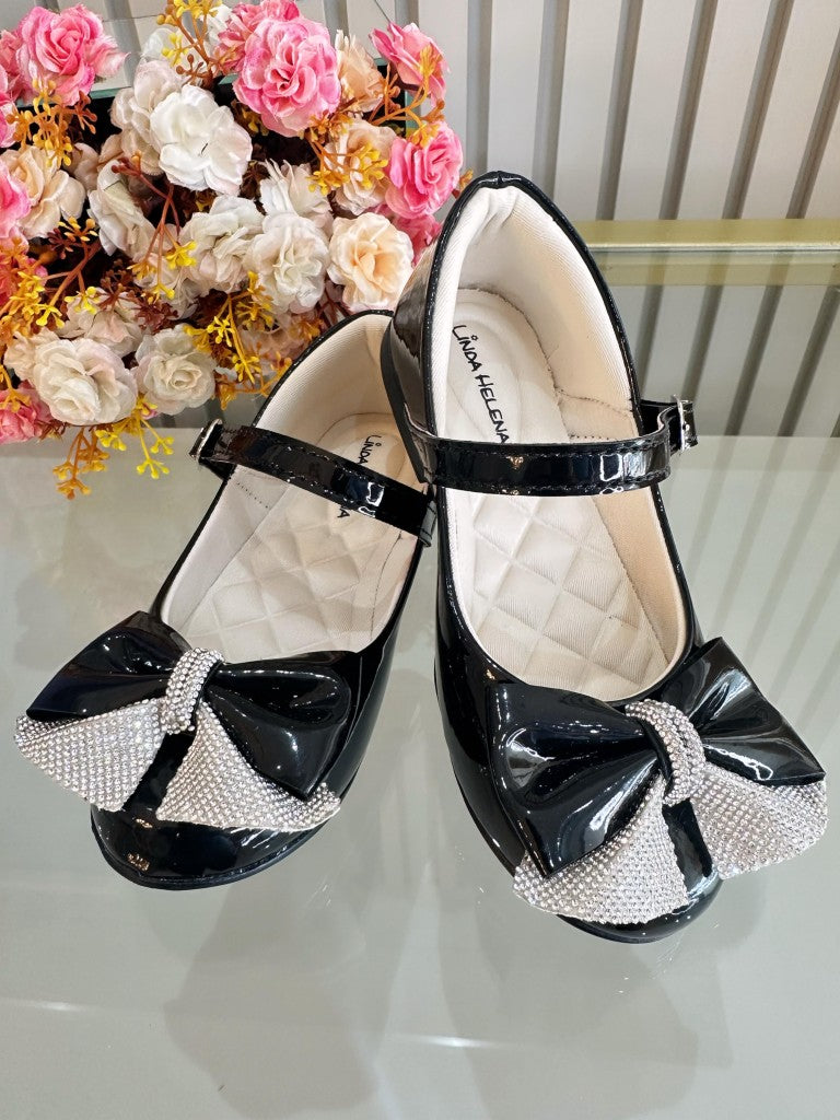 Zapatos infantiles de charol negro con aplique de lazo de diamantes de imitación 