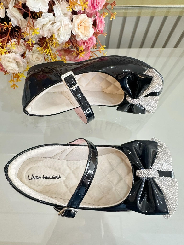 Zapatos infantiles de charol negro con aplique de lazo de diamantes de imitación 