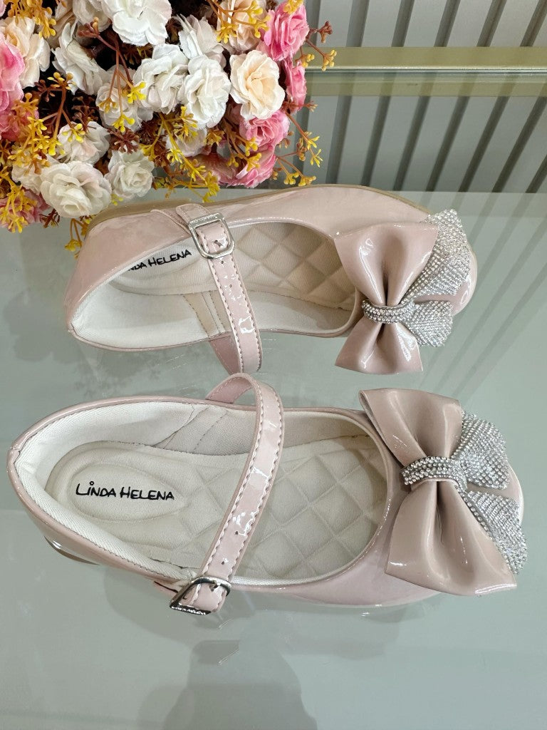 Zapatos infantiles de charol color nude con aplique de lazo de diamantes de imitación 