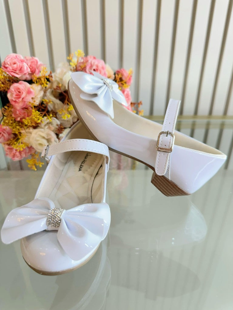 Zapato de tacón de charol blanco con lazo y aplique de pedrería