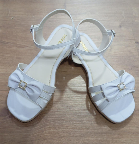 Sandalias blancas de tiras para niños con lazo y pedrería de lujo 