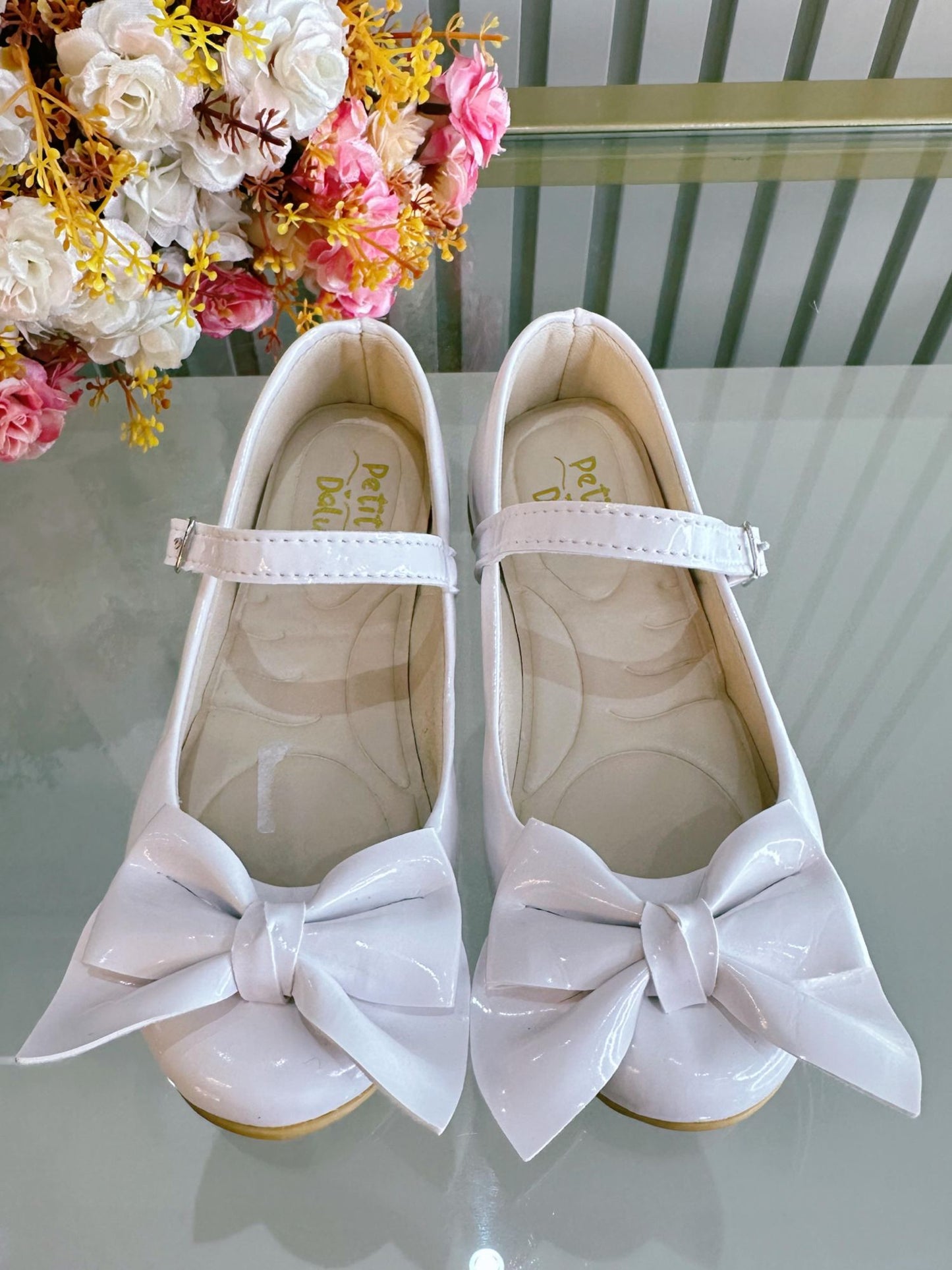Zapatos infantiles de charol blanco con aplique de lazo de lujo